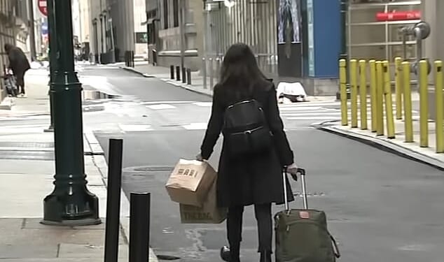 A guest is seen abruptly leaving the Sonder hotel she was staying at in Philadelphia with her luggage in tow