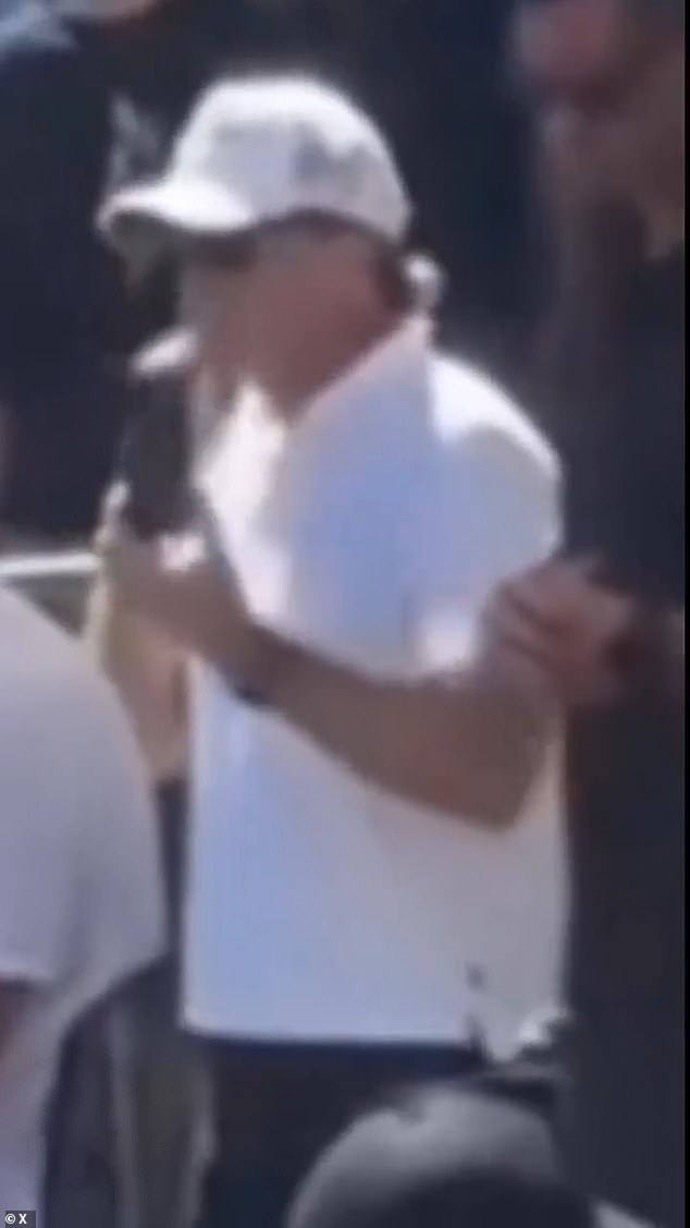 A user on X questioned two men who were allegedly 'giving hand signals' including one who was seen adjusting his hat. Harpole said it was merely a coincidence