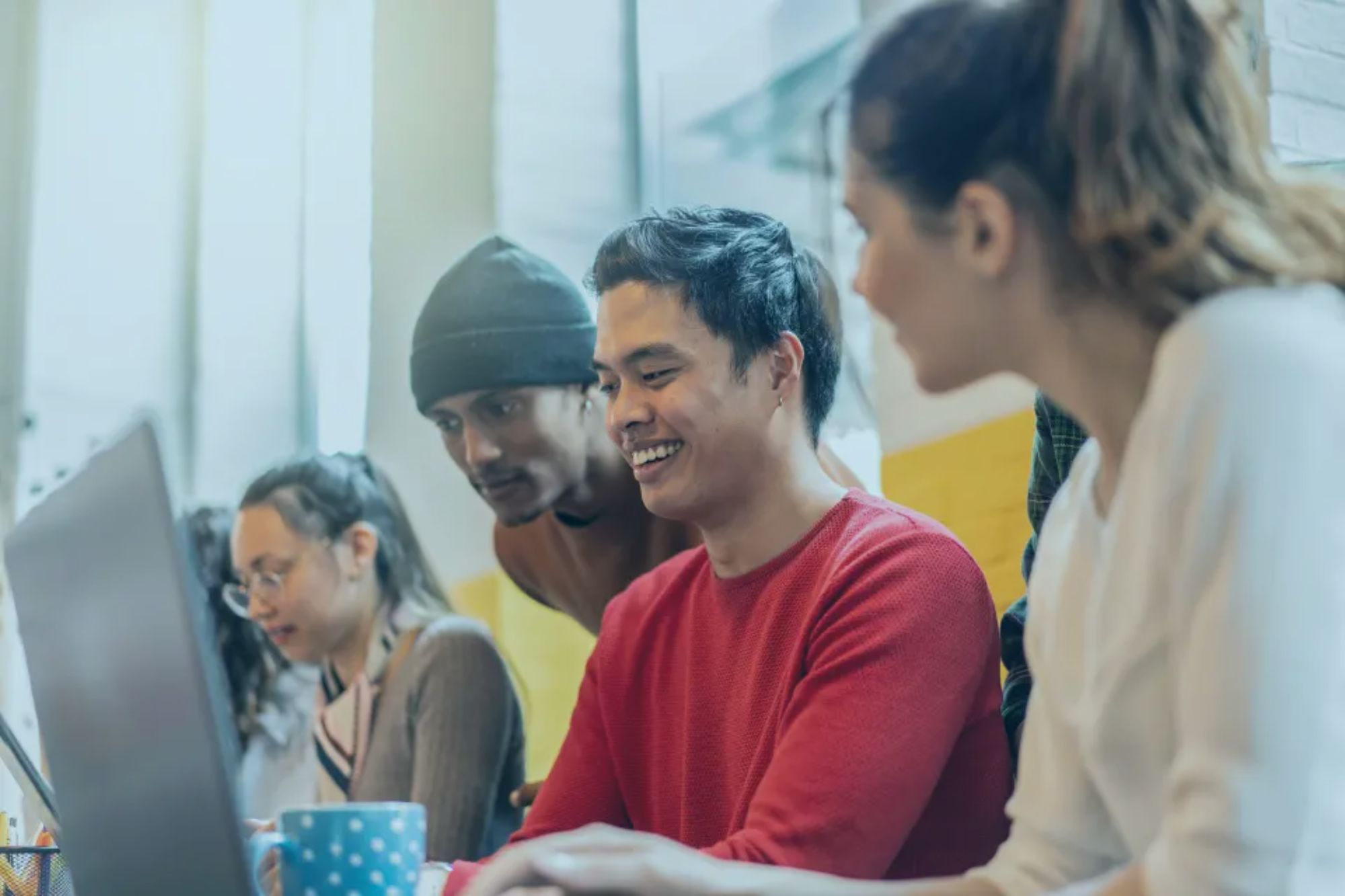An image collage containing 1 images, Image 1 shows Young multiethnic team working on computers in a creative office