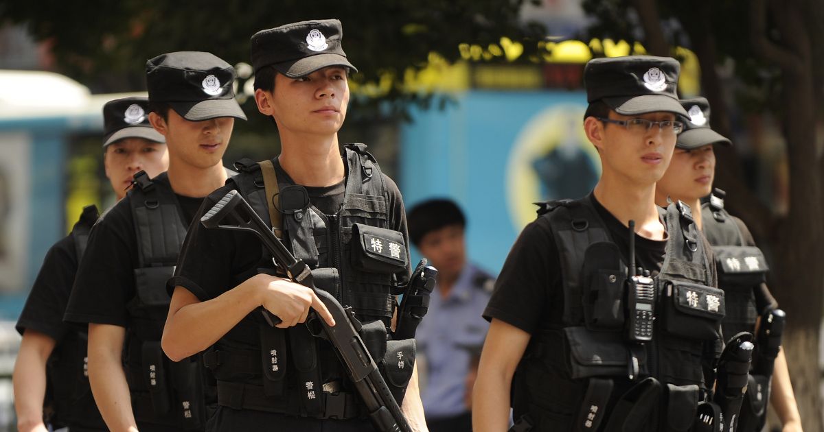 Armed Chinese police patrol a street in Urumqi, China in the Xinjiang region on July 3, 2010.