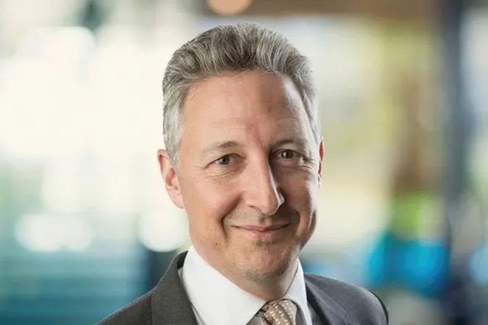 An image collage containing 1 images, Image 1 shows Rob Burdett, an asset manager, in a suit and tie