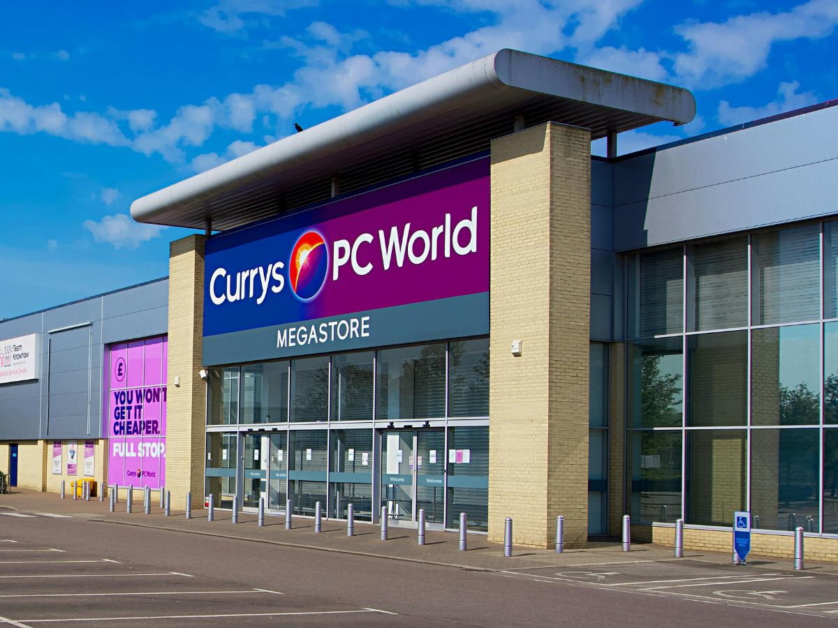 Exterior of a Currys PC World Megastore with a large sign and glass entrance.