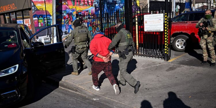 U.S. Border Patrol officers arrest an individual Nov. 6 in the Little Village neighborhood of Chicago, Illinois. (Joshua Lott - The Washington Post / Getty Images)