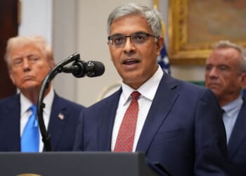 Director of the National Institutes of Health Jay Bhattacharya is seen at a September meeting with President Donald Trump, left, and Health and Human Services Secretary Robert F. Kennedy Jr., right.