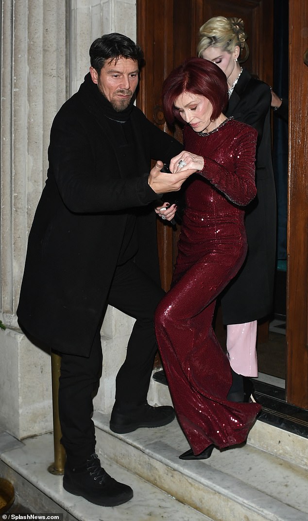 Sharon Osbourne was escorted of a high-end London restaurant by a very familiar face as she made her first public appearance since Ozzy's death on Wednesday
