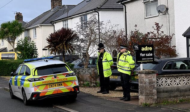 Police outside home where dog savaged a nine-month-old baby to death in South Wales