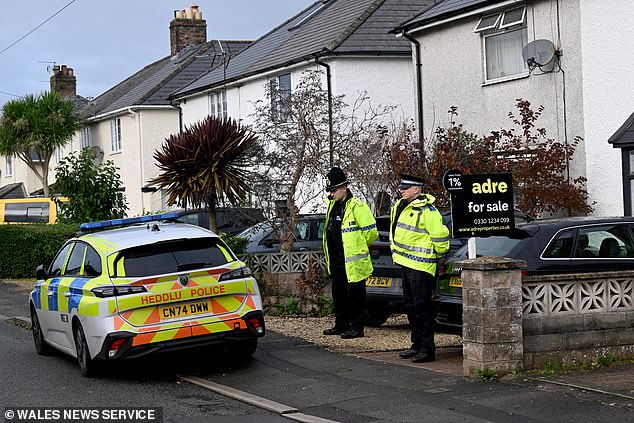 Police outside home where dog savaged a nine-month-old baby to death in South Wales