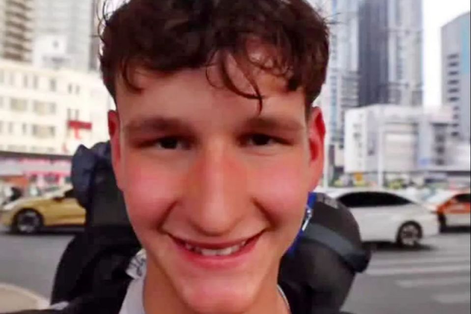 An image collage containing 1 images, Image 1 shows Tommy Lamb, a super-fan known as Cheese Naan, smiling at the camera with a city street in the background