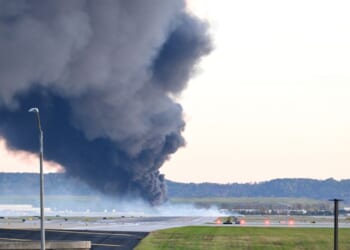 Fire and smoke mark where a UPS cargo plane crashed near Louisville Muhammad Ali International Airport on Nov. 4, 2025, in Louisville, Kentucky.