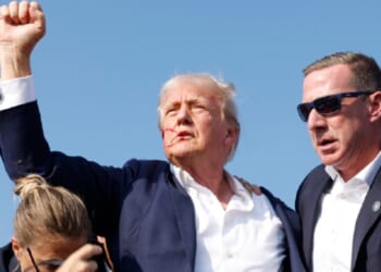 Now-President Donald Trump raises his right fist high as he is rushed offstage after an assassination attempt July 13, 2024, in Butler, Pennsylvania.