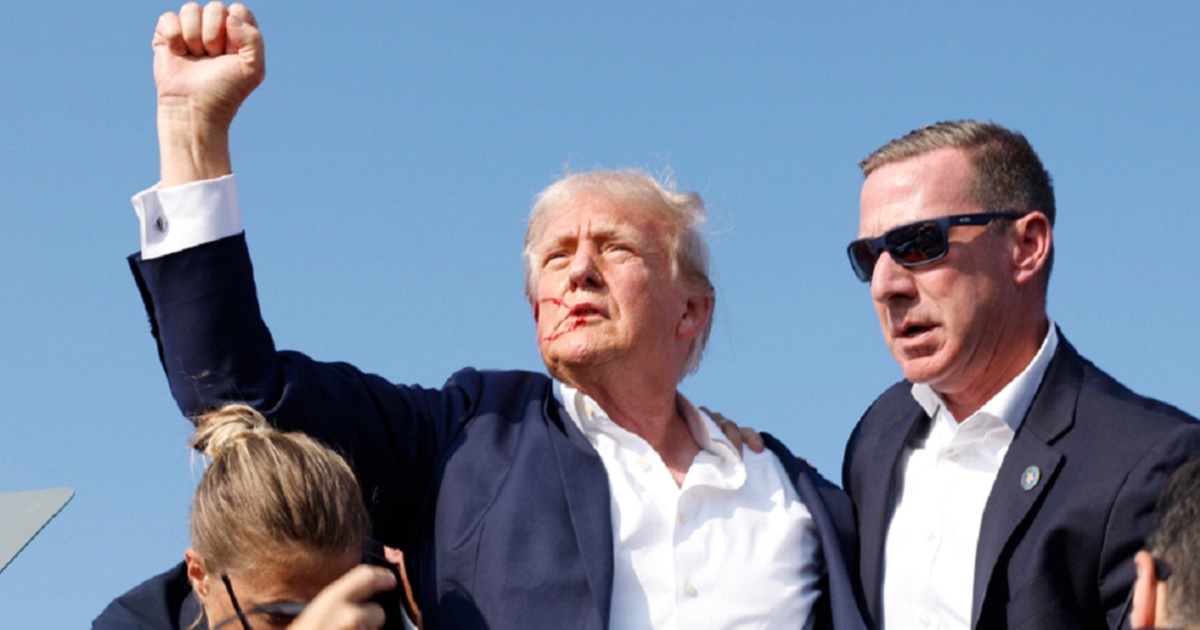 Now-President Donald Trump raises his right fist high as he is rushed offstage after an assassination attempt July 13, 2024, in Butler, Pennsylvania.