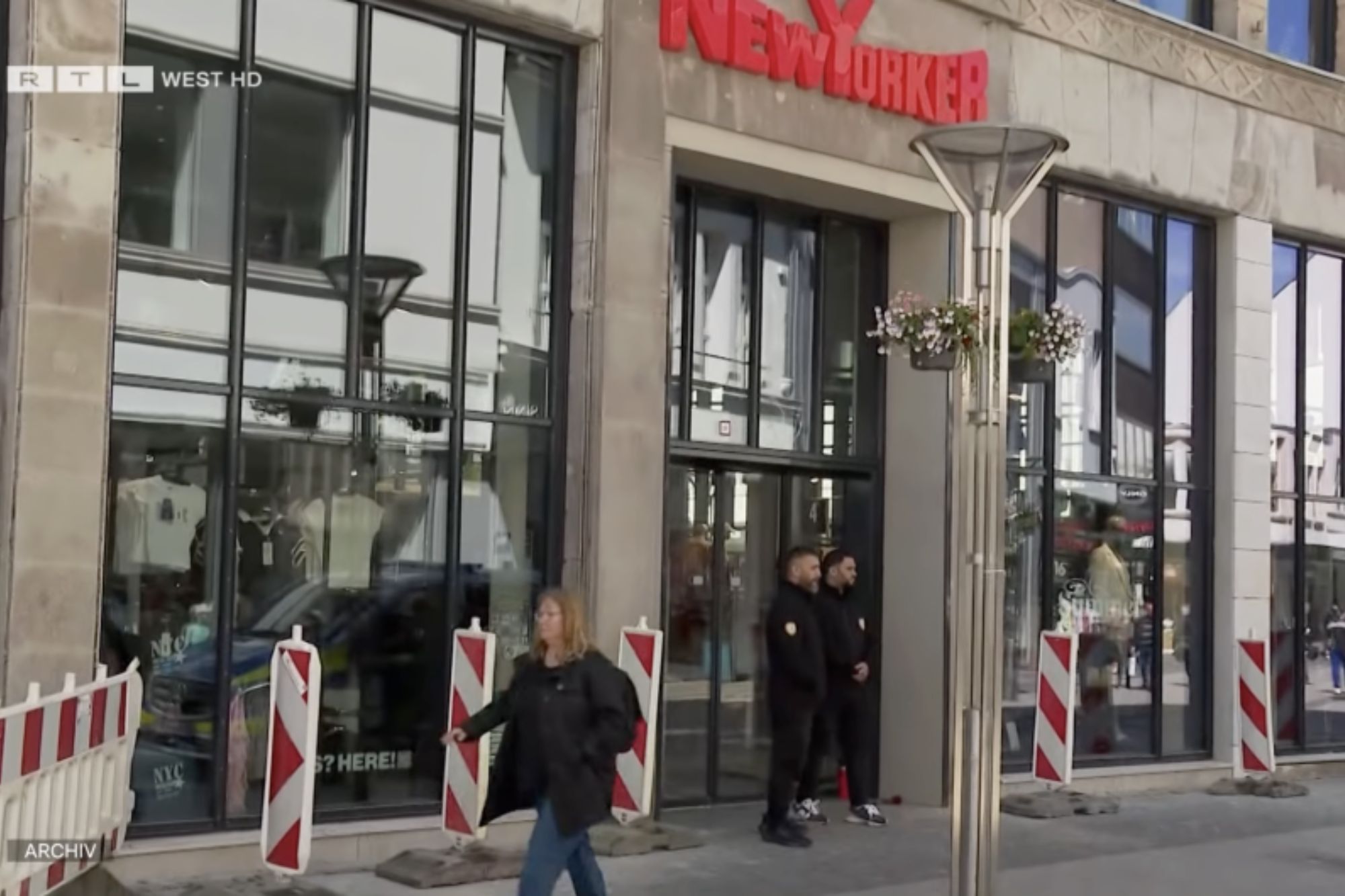 An image collage containing 1 images, Image 1 shows Exterior of the New Yorker fashion store in Krefeld, Germany, where a knife attack occurred