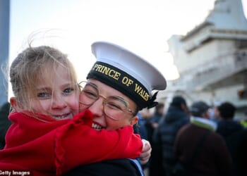 Chloe Pinkerton is greeted by cousin Ava after HMS Prince of Wales aircraft carrier arrives at Portsmouth Naval Base, on November 30, 2025 in Portsmouth, England