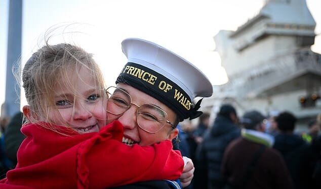 Chloe Pinkerton is greeted by cousin Ava after HMS Prince of Wales aircraft carrier arrives at Portsmouth Naval Base, on November 30, 2025 in Portsmouth, England