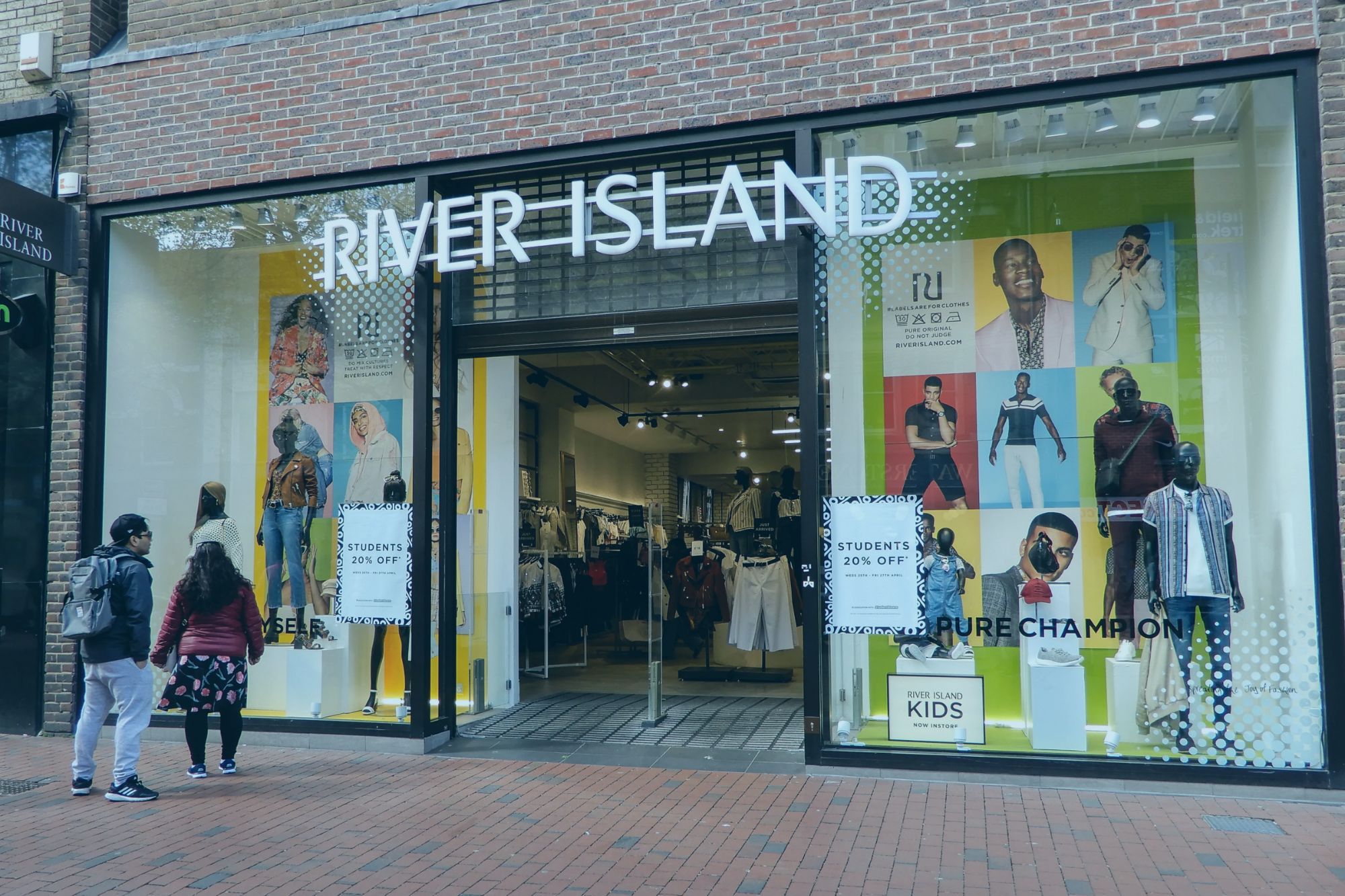 An image collage containing 1 images, Image 1 shows Facade of a River Island clothing store with mannequins in the display windows