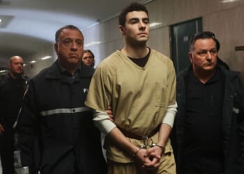 Luigi Mangione is escorted by police as he arrives for a Sept. 16 hearing at Manhattan Criminal Court in the killing of UnitedHealthcare CEO Brian Thompson.
