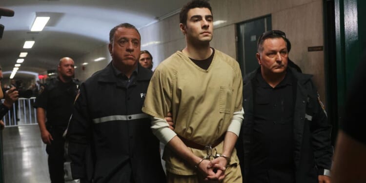 Luigi Mangione is escorted by police as he arrives for a Sept. 16 hearing at Manhattan Criminal Court in the killing of UnitedHealthcare CEO Brian Thompson.