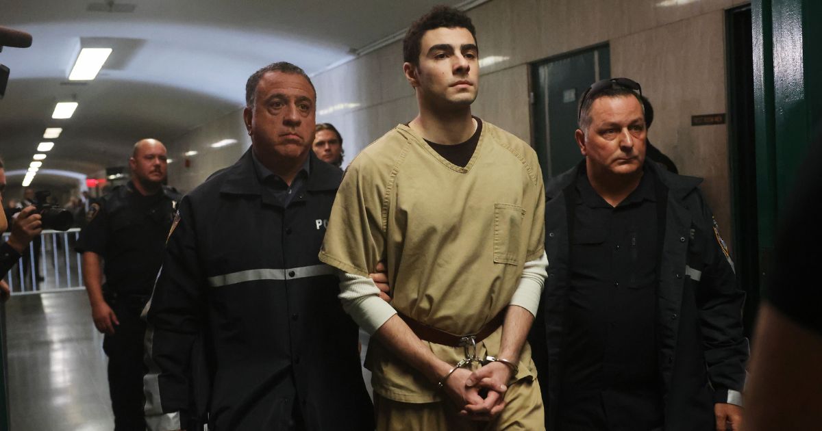 Luigi Mangione is escorted by police as he arrives for a Sept. 16 hearing at Manhattan Criminal Court in the killing of UnitedHealthcare CEO Brian Thompson.