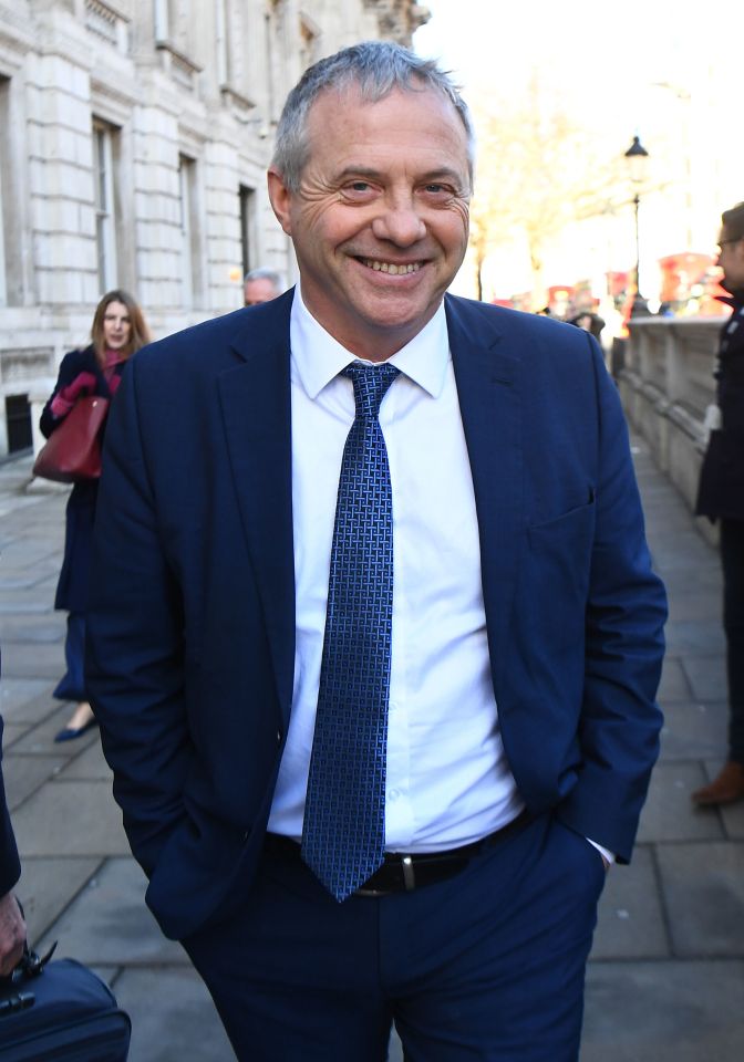 John Mann, a senior Labour backbencher, smiling while walking outdoors.
