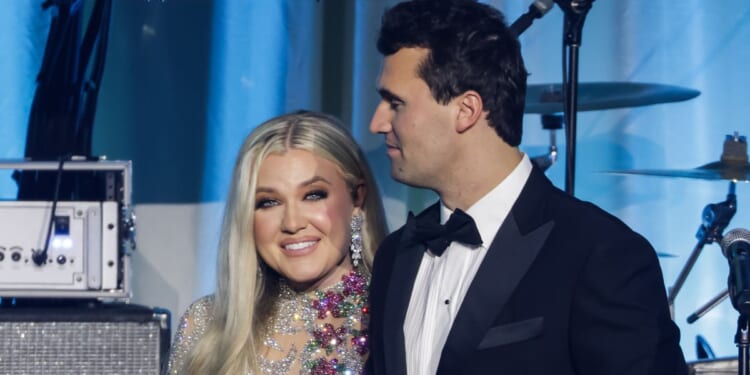 Charlie Kirk, right, is seen with his wife Erika Kirk on stage during the Turning Point USA Inaugural-Eve Ball in Washington, D.C., on Jan. 19.