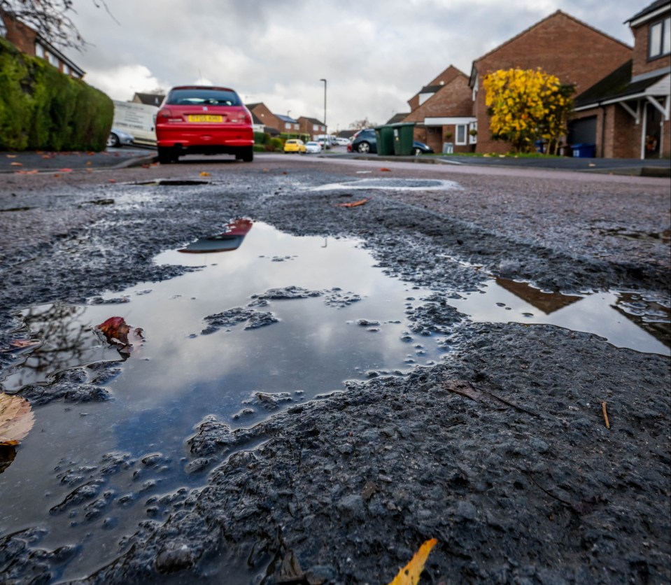 Potholes on a street in Horsham Close, Banbury, Oxfordshire.