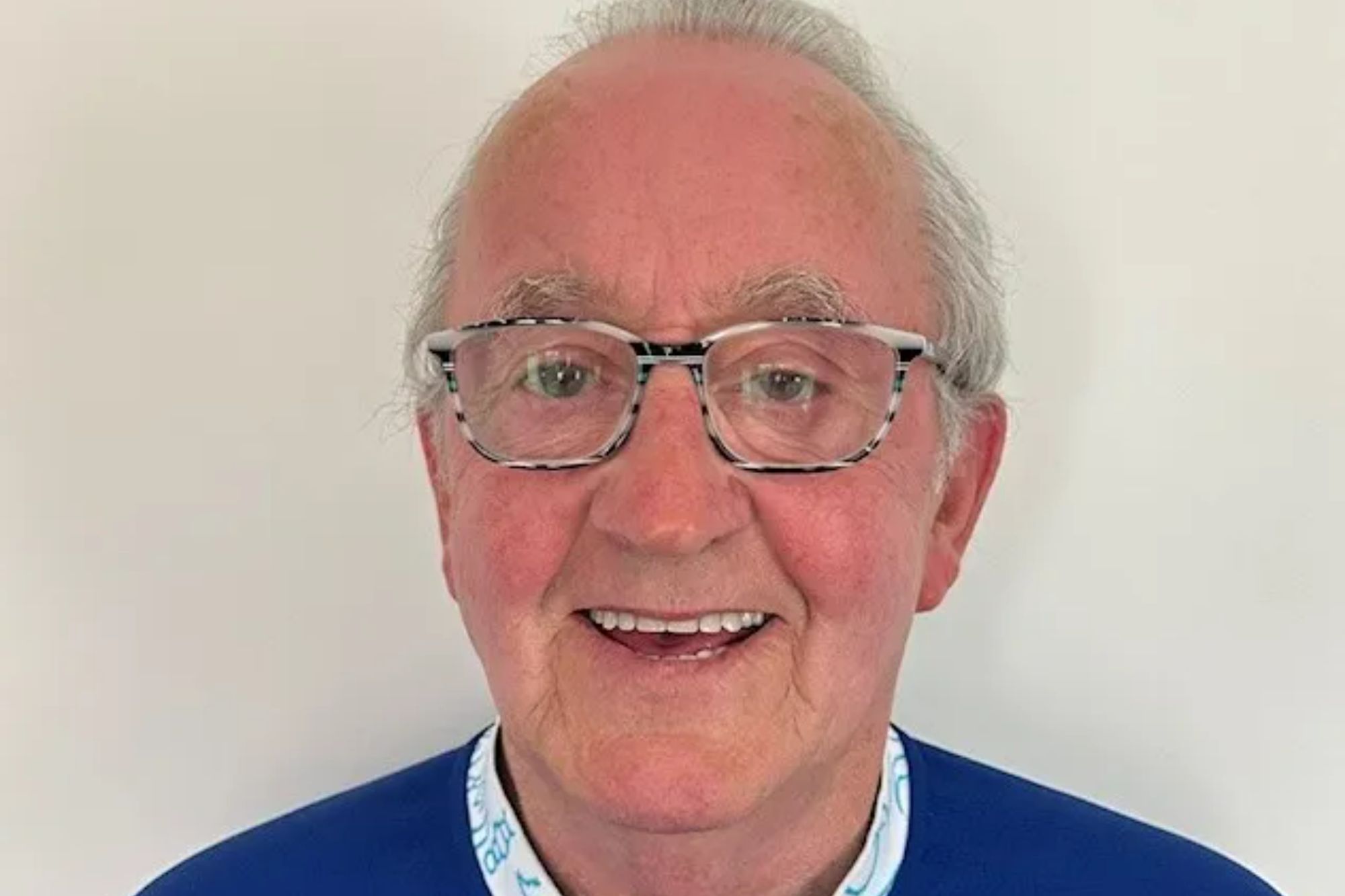 An image collage containing 1 images, Image 1 shows John Gerard Boyle smiling while wearing glasses and a blue shirt