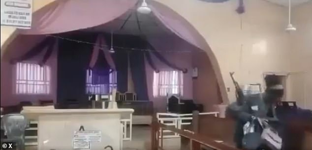 One of the gunmen can be seen gathering the belongings of frightened worshippers who tried to flee for their lives