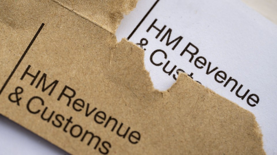 Torn brown envelope revealing a white letter from "HM Revenue & Customs".