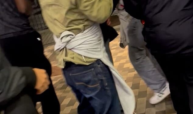 In a video, one man held a rag to his head as crimson-coloured blood seeped through