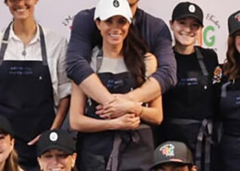 Harry wraps his arms around his wife in a show of unity in a new image of the couple released last night