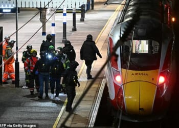 Police on the platform at Huntingdon Station in Cambridgeshire on Saturday night following the attack