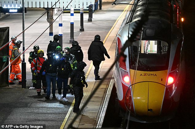 Police on the platform at Huntingdon Station in Cambridgeshire on Saturday night following the attack