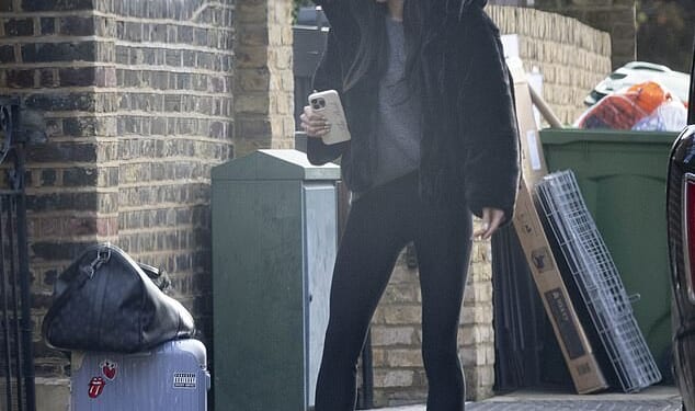 Holly Ramsay clutched a 'Bride' phone case as she broke cover on Thursday morning for the first time since her feud with fiancé Adam Peaty 's family came to light