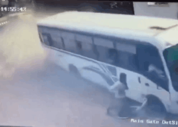 Horror moment out-of-control bus misses parked cyclist by just inches as it crashes into building