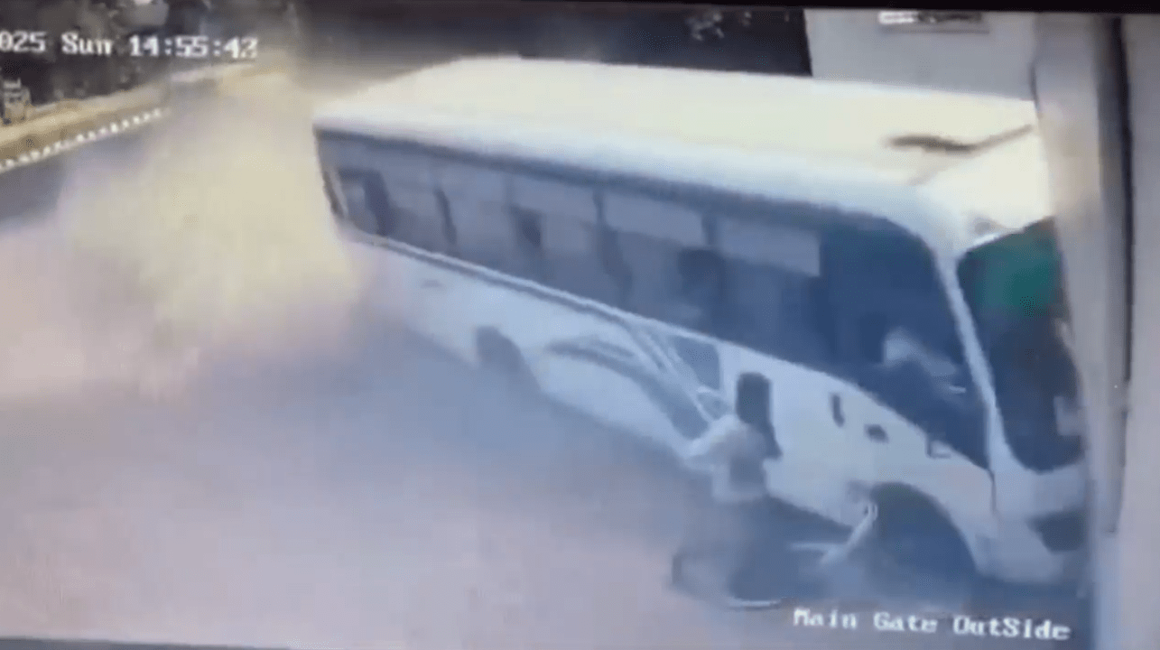 Horror moment out-of-control bus misses parked cyclist by just inches as it crashes into building