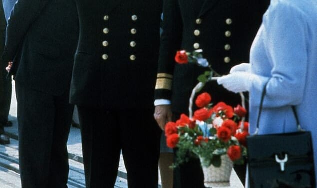 Queen Elizabeth has left King Charles paying the price for the many scandals of her beloved son Andrew. Pictured: Queen Elizabeth ll, gives her son Andrew a rose which he promptly puts in his mouth after they have disembarked from HMS Invincible upon his return from the Falklands war on September 17, 1982 in Portsmouth, England
