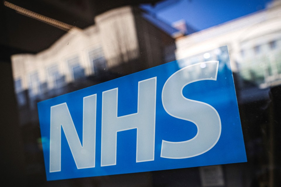 The NHS (British National Health Service) logo on a window.