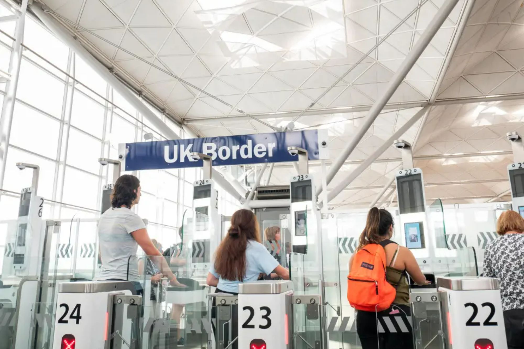An image collage containing 1 images, Image 1 shows Passengers using ePassport gates at UK Border control in Stansted Airport