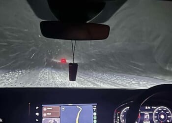 Motorist seen driving through the dangerous snowy conditions