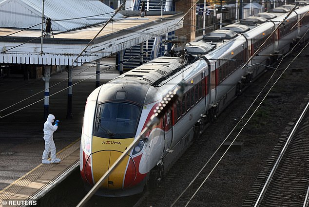 A forensic officer inspects the London North Eastern Railway (LNER) train after a mass stabbing
