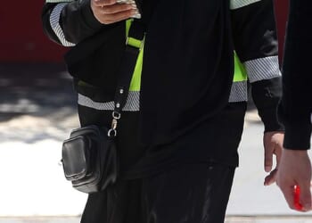 A woman is seen wearing a hi-vis, work boots and a niqab on Tuesday in western Sydney