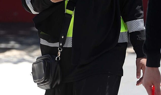 A woman is seen wearing a hi-vis, work boots and a niqab on Tuesday in western Sydney