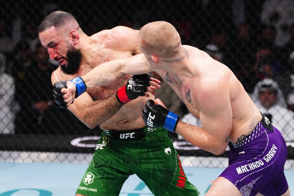 Ian Machado Garry punches Belal Muhammad in a welterweight fight.