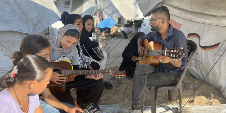 In Gaza, a music teacher sings above the din of war