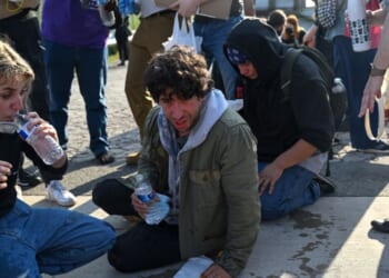 Demonstrators protesting outside the U.S Immigration and Customs Enforcement facility, including Democratic congressional candidate Kat Abughazaleh, 26, left, react after being tear-gassed on Sept. 19, 2025, in Broadview, Illinois.