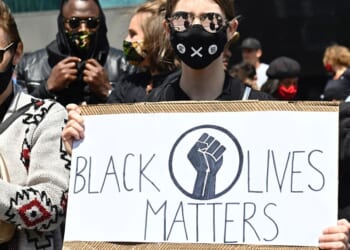 A protester holds up a sign that says "Black Lives Matter" at a protest in Berlin on June 6, 2025.