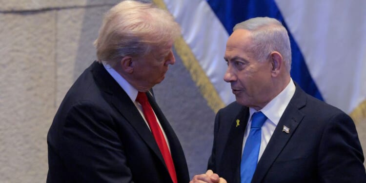 President Donald Trump Israeli and Prime Minister Benjamin Netanyahu interact after Netanyahu addressed the Knesset on Oct. 13, 2025, in Jerusalem.