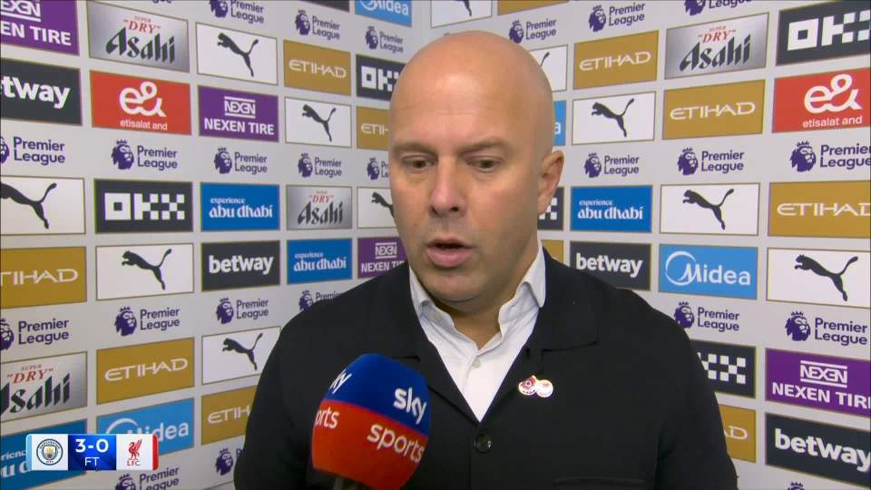 A man being interviewed by Sky Sports with a backdrop of various Premier League sponsor logos.