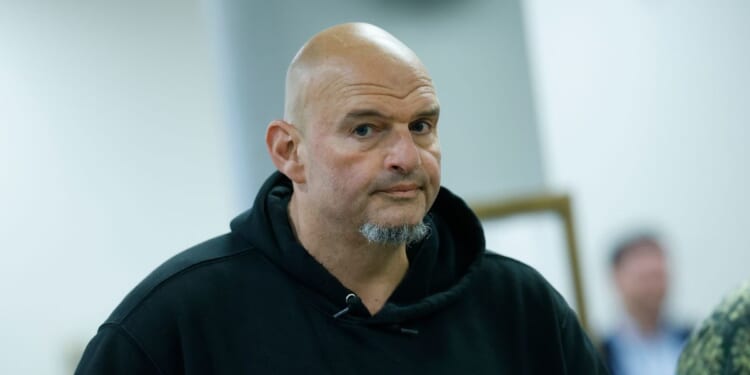 Sen. John Fetterman, a Democrat from Pennsylvania, walks to vote at the U.S. Capitol on Oct. 8, 2025, in Washington, D.C.
