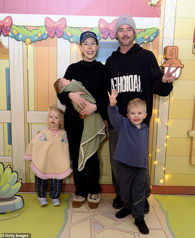 Katherine Ryan cradled her baby girl, Holland, as she and her family attended a Bluey's Aussie Christmas event at Bluewater Shopping Centre in Greenhithe on Saturday